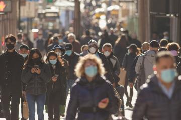  Crowd of people walking street wearing masks during covid19 coronavirus pandemic