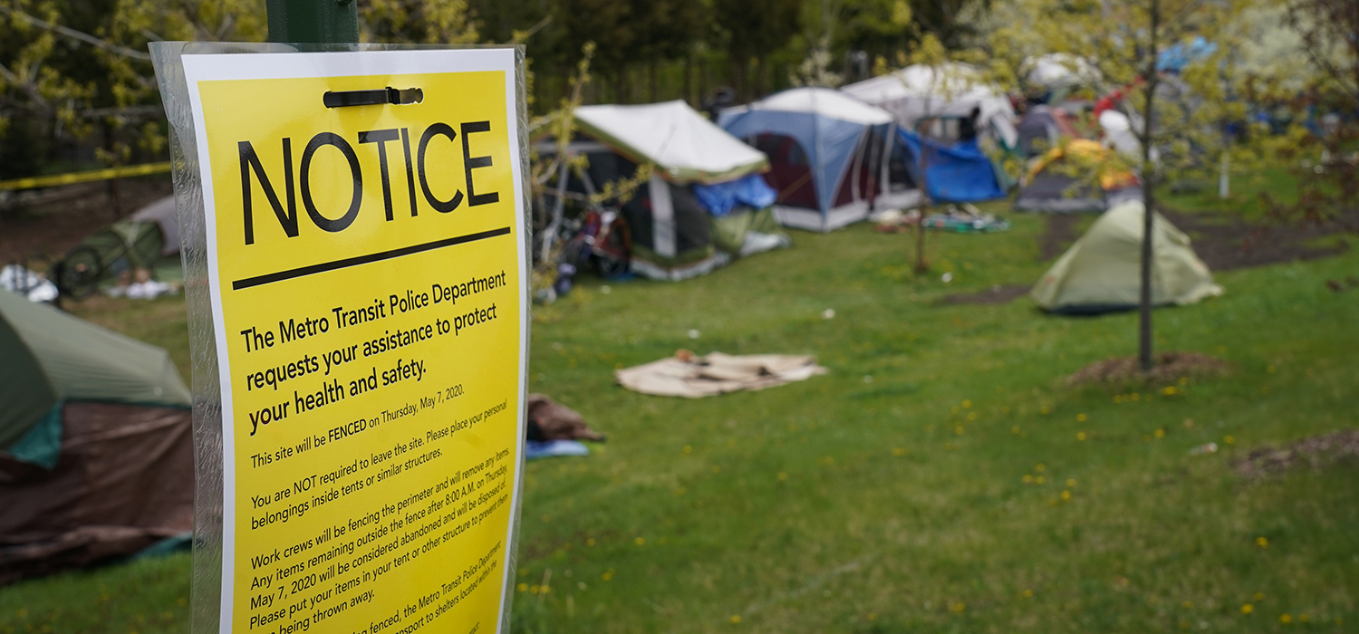 A sign a fast-growing homeless encampment 