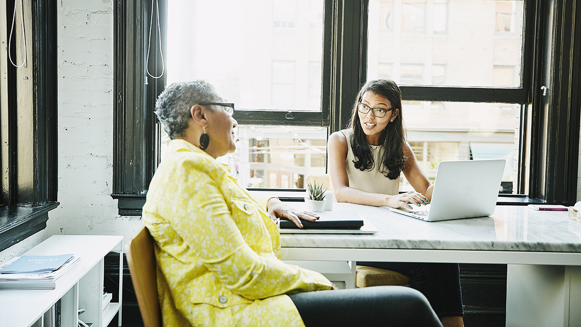 Two women talking at a table