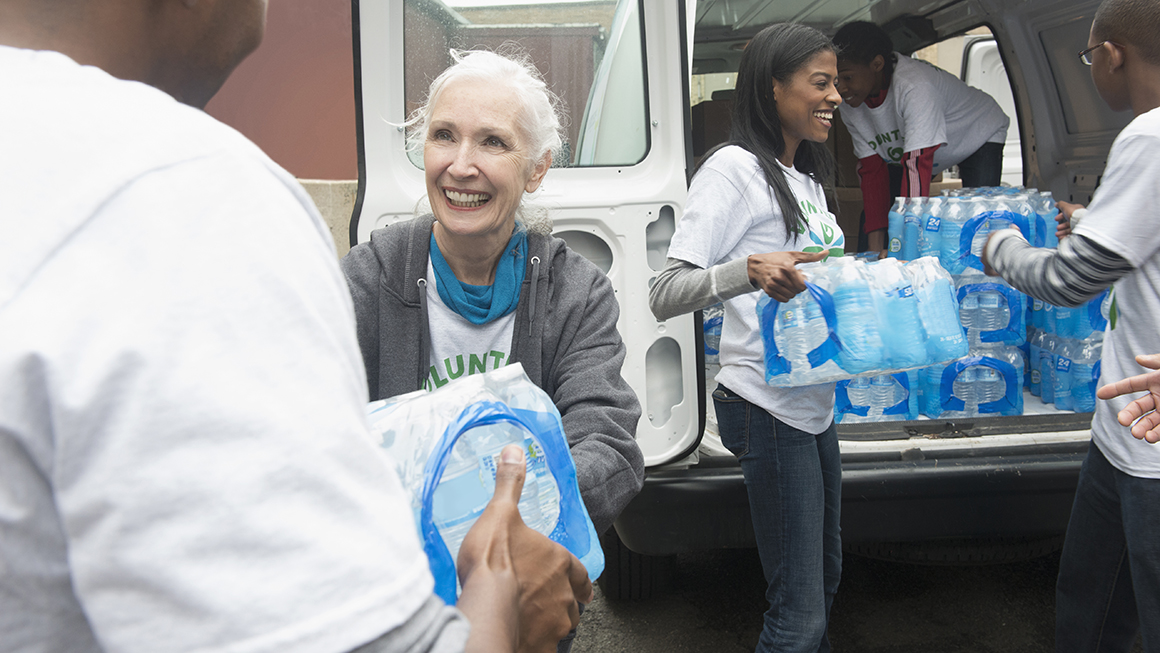 Volunteers handing out water bottles.