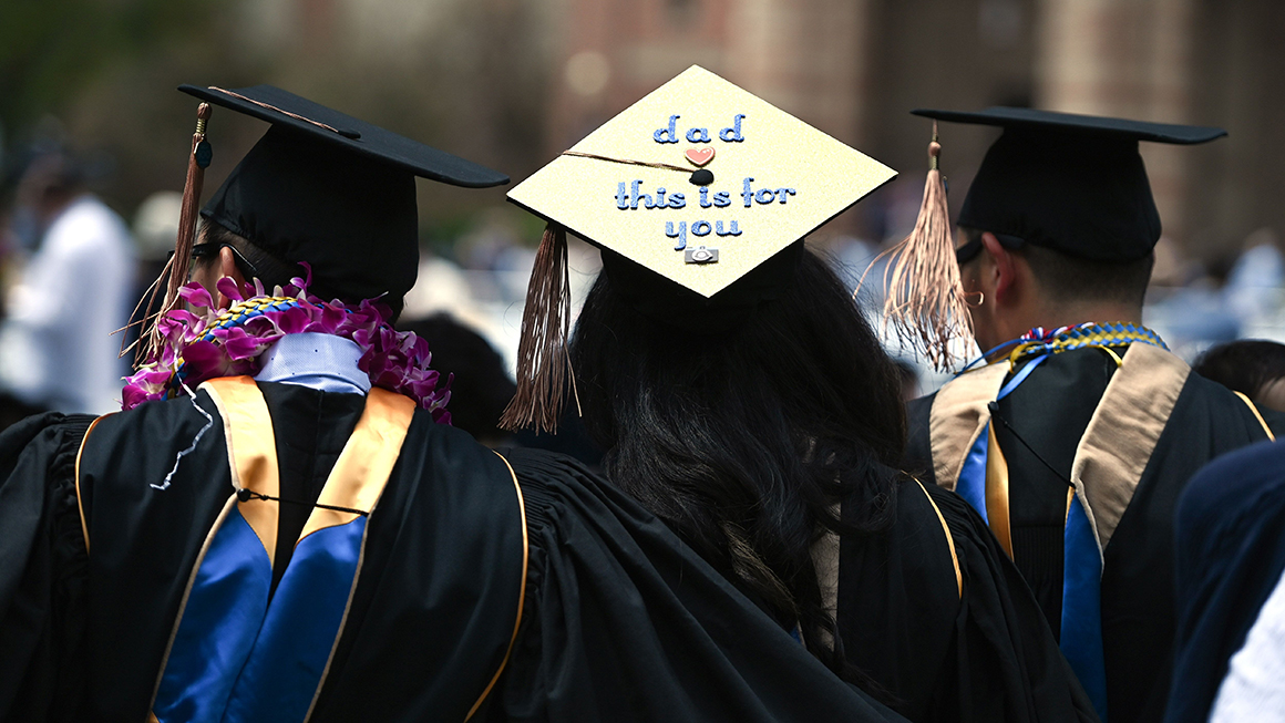Students wearing academic regalia attend their graduation ceremony at the University of California Los Angeles (UCLA