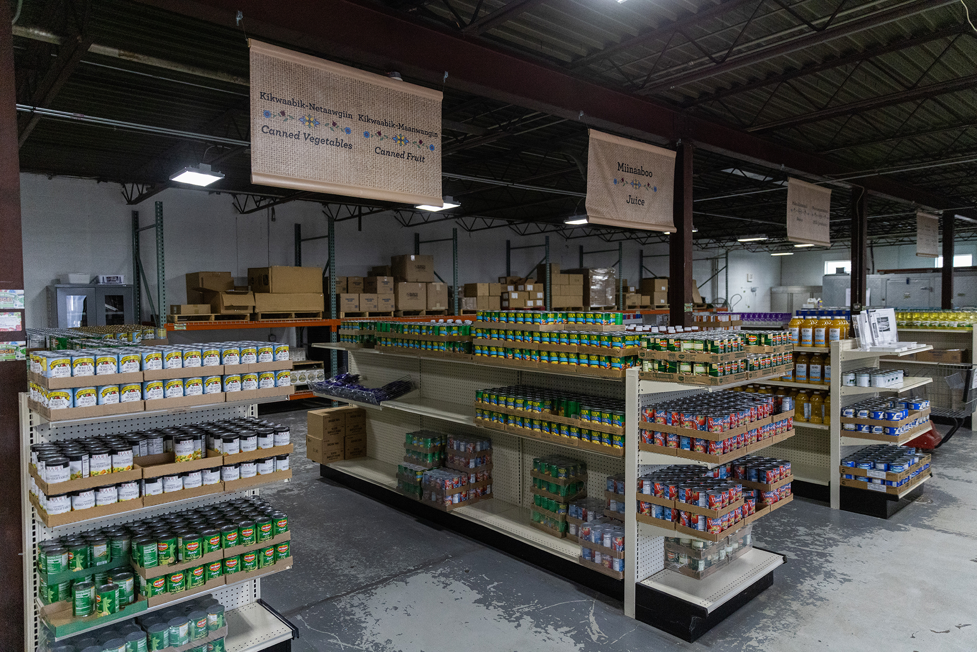 Rows of canned goods and aisle signs.