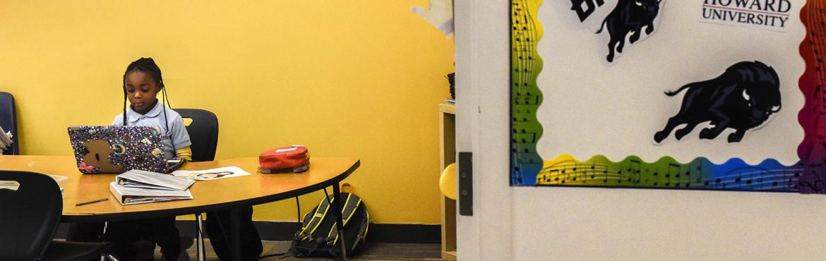 MaKenzie, 6, works on a laptop while her mom attends a meeting at DC Prep Charter Elementary School on December, 11, 2018 in Washington, DC.