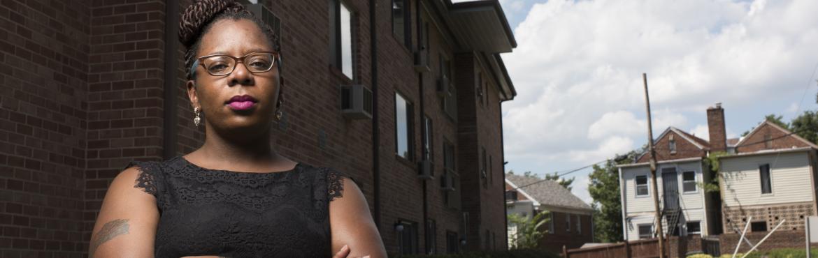 Jasmine White outside the Hawaiian Apartments building
