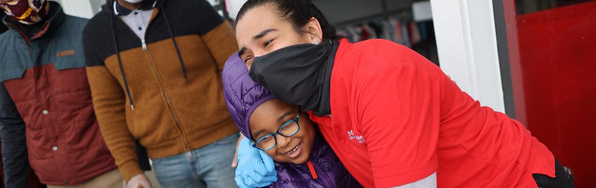 healthworker hugging community member
