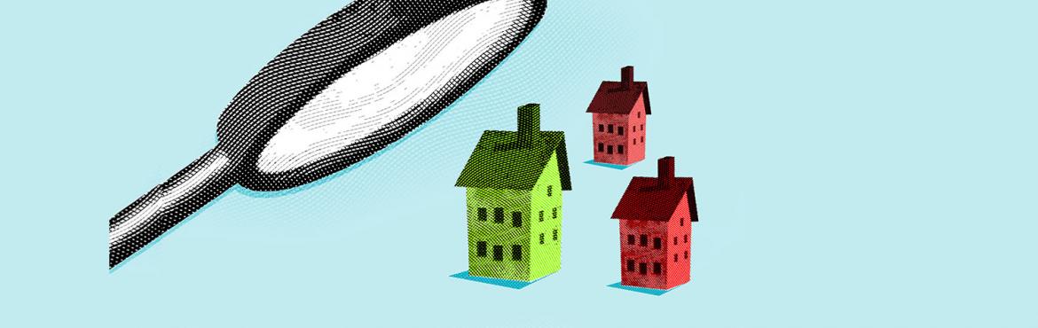 photo of magnifying glass looking at houses