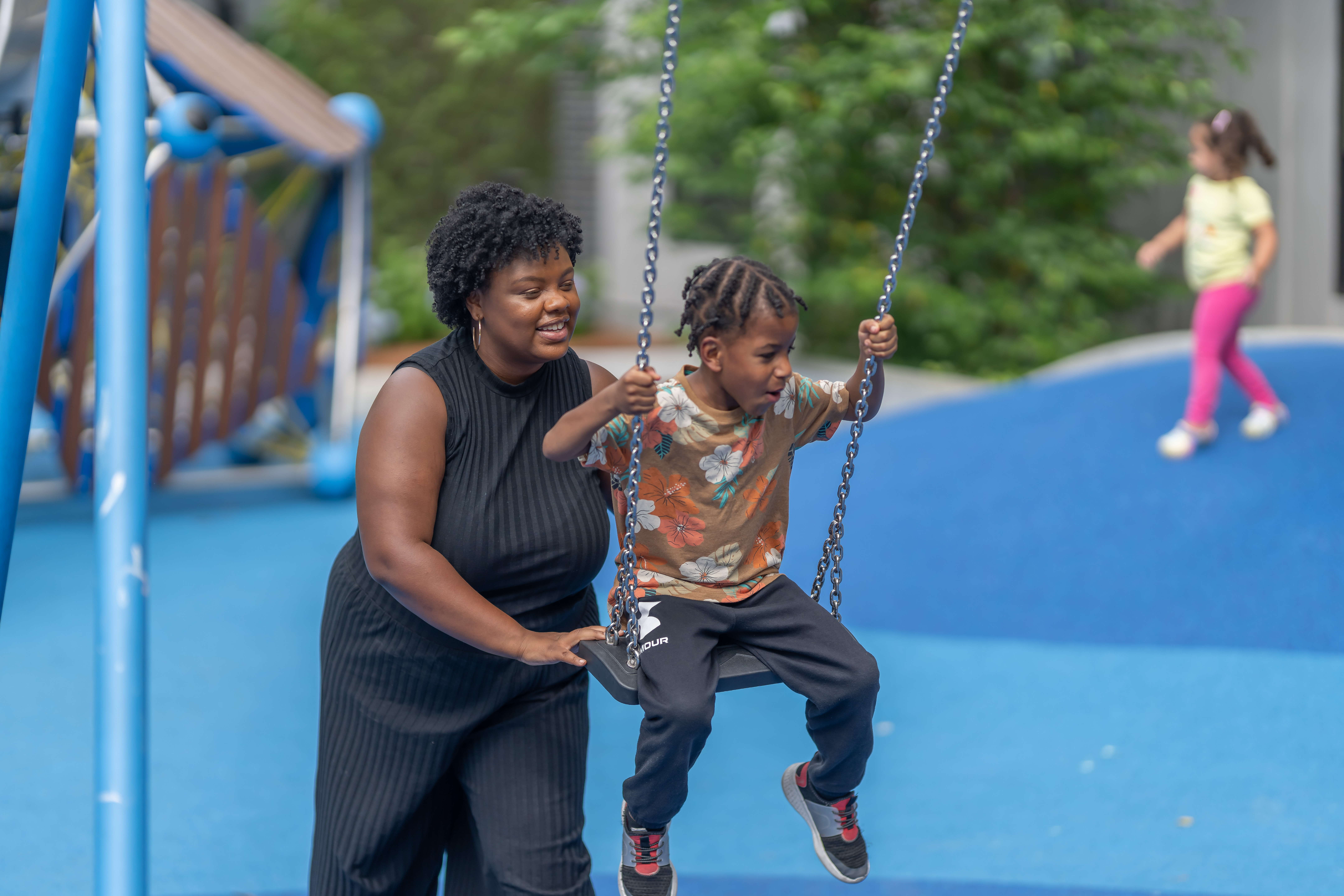 Marissa, a resident of POAH’s Flat 9 at Whittier Apartments in Roxbury, Massachusetts, plays with her son Jordan at the property’s playground.