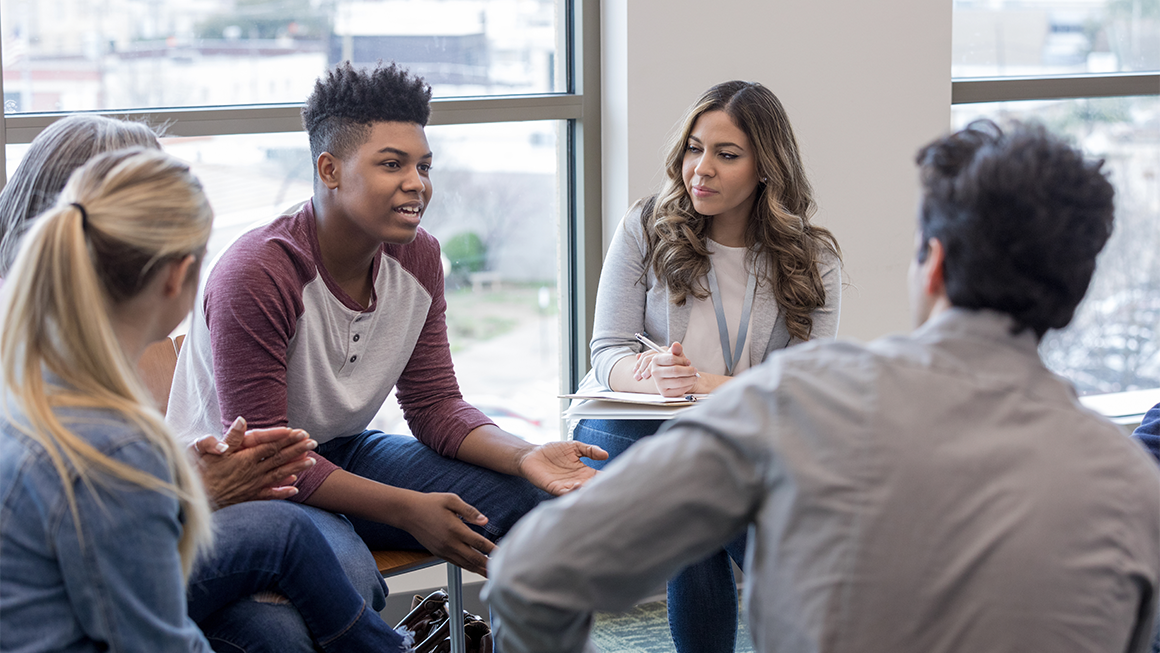 In therapy, teen boy shares life experiences with group