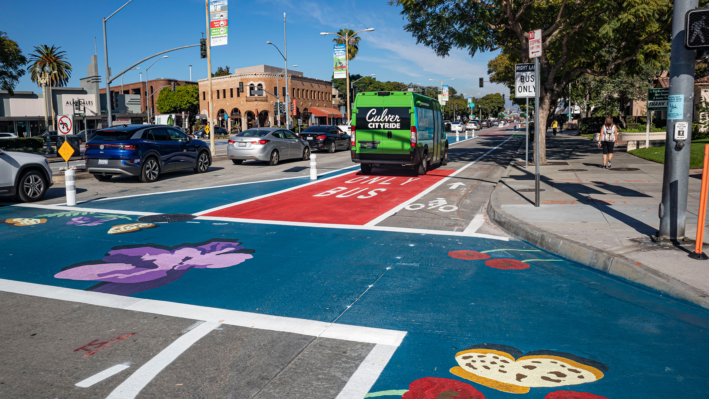 photo of pedestrian, traffic, bus, and bicycle lanes in downtown area to reduce congestion and emissions