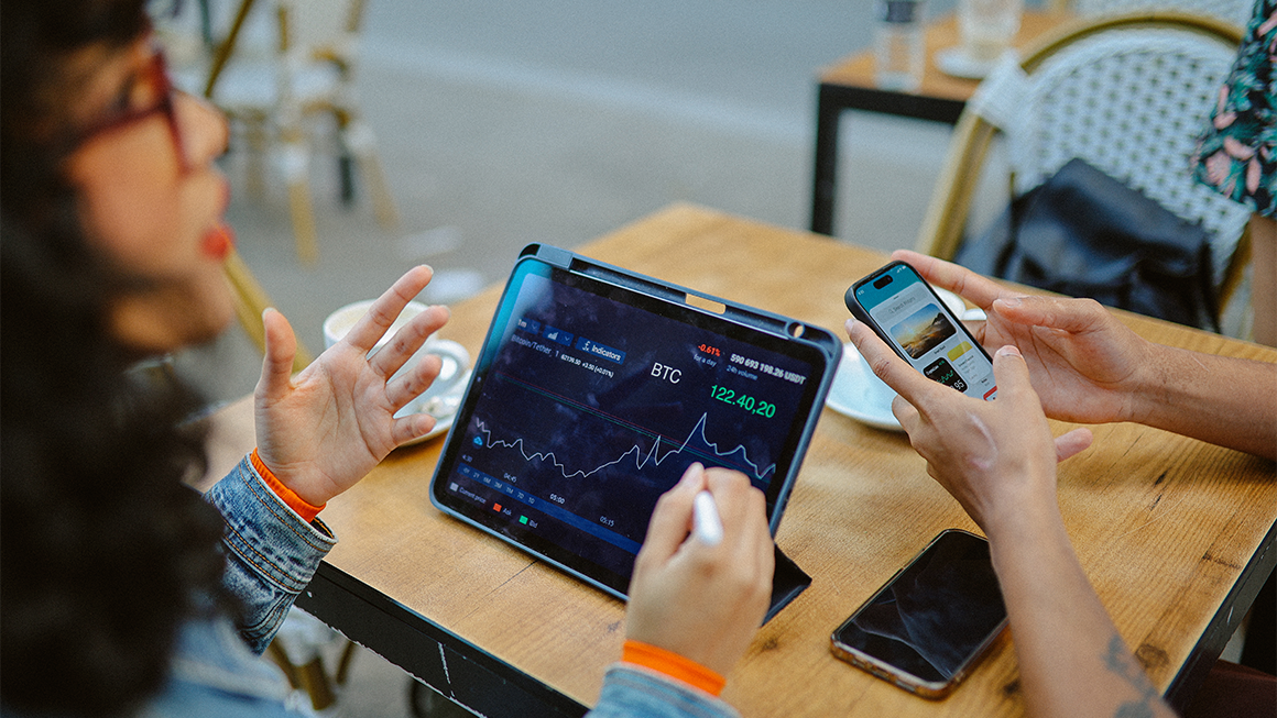 photo of young people discussing and researching finance and crypto currencies