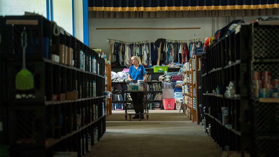 BURNSVILLE, NORTH CAROLINA - SEPTEMBER 17: A woman browses for supplies at the Bee Log Community and Relief Center on September 17, 2025 in Burnsville, North Carolina. After Hurricane Helene, the abandoned Bee Log Elementary School turned into a grassroots disaster relief hub.