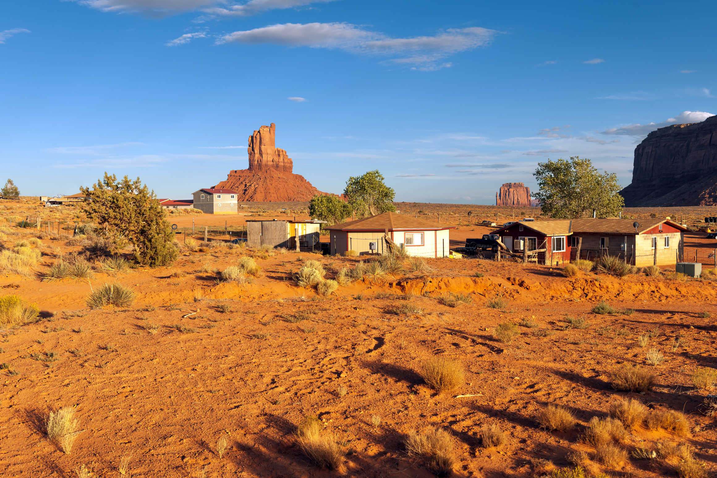 Desert homes beneath red rock buttes.