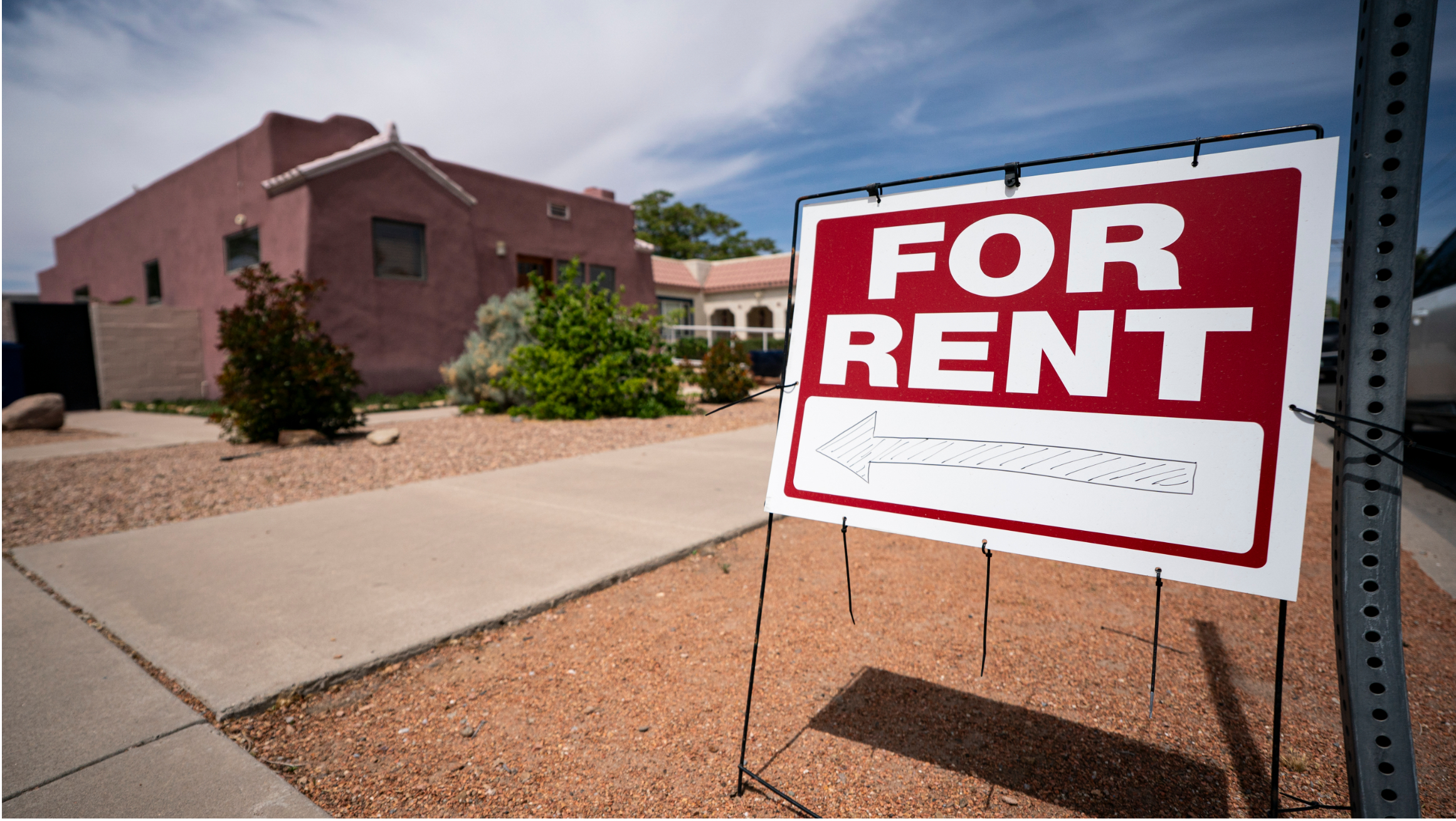 For Rent sign in front of a single-family home.