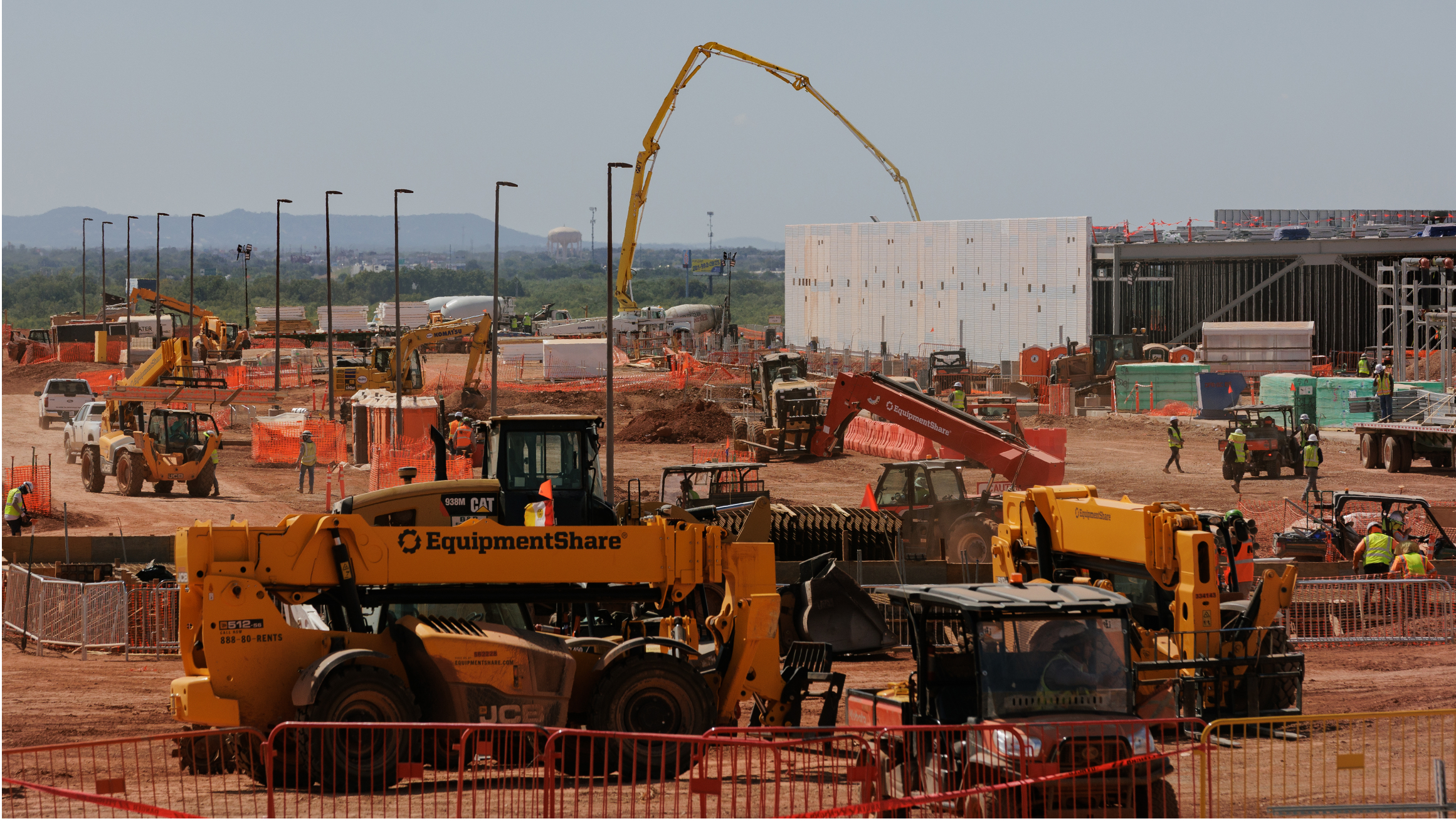 Construction site with heavy equipment and workers.