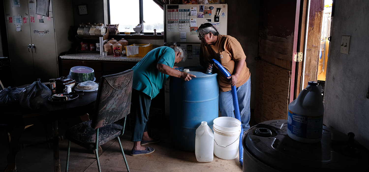 A member of the Navajo Nation receives their monthly water delivery