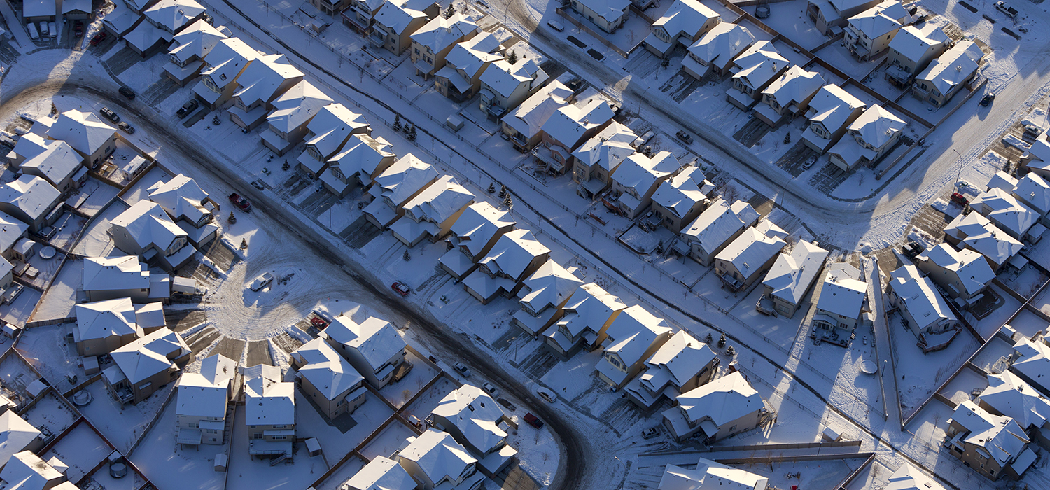 A neighborhood of snow-covered single-family homes