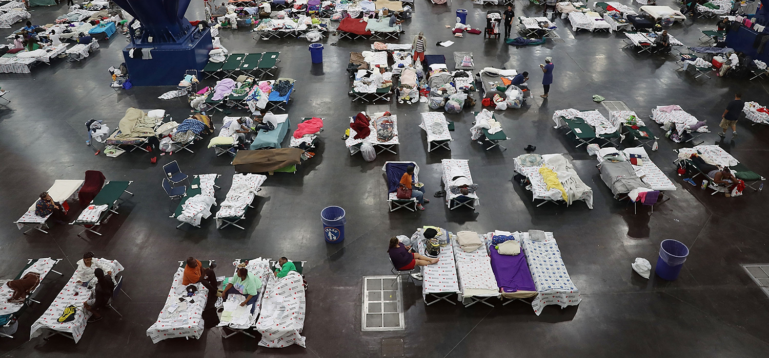 Hurricane evacuees shelter in a convention center