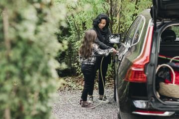 Woman charging an electric car. 