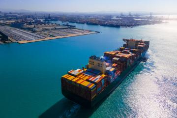 A shipping container boat on the water
