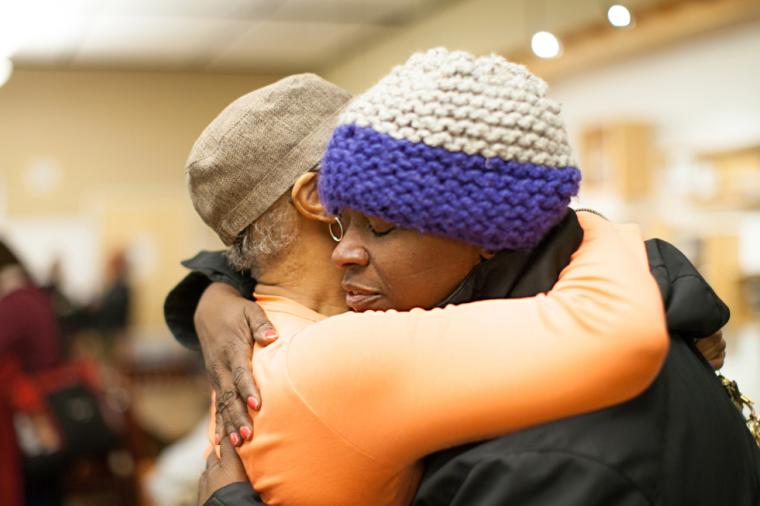 Two women embrace in the Day Center community space at the Downtown Women’s Center in Los Angeles. Photo provided by the Downtown Women’s Center.