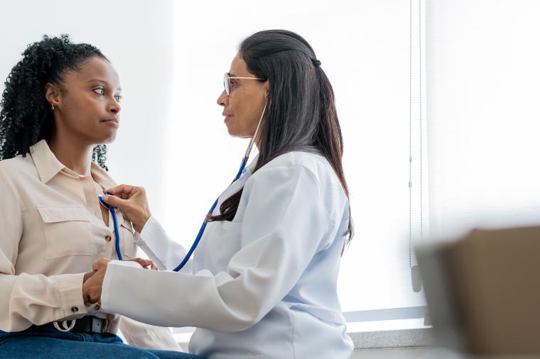 Doctor checking patients heart