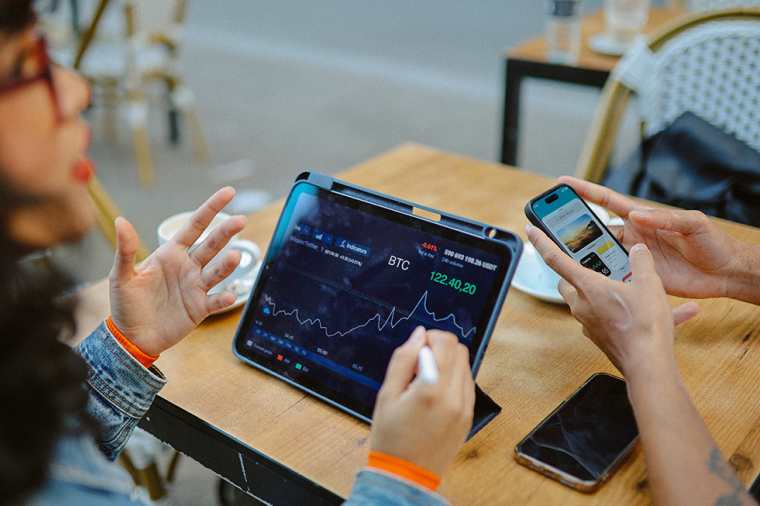 photo of young people discussing and researching finance and crypto currencies