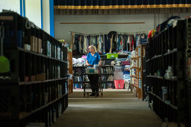 BURNSVILLE, NORTH CAROLINA - SEPTEMBER 17: A woman browses for supplies at the Bee Log Community and Relief Center on September 17, 2025 in Burnsville, North Carolina. After Hurricane Helene, the abandoned Bee Log Elementary School turned into a grassroots disaster relief hub.