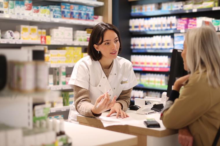 pharmacist dispensing medication to a patient.