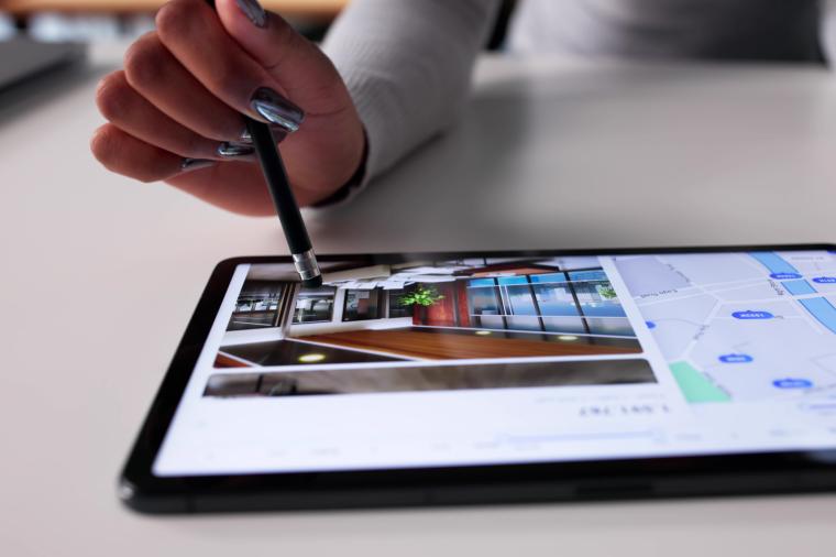 A photo of a person browsing properties on a tablet.