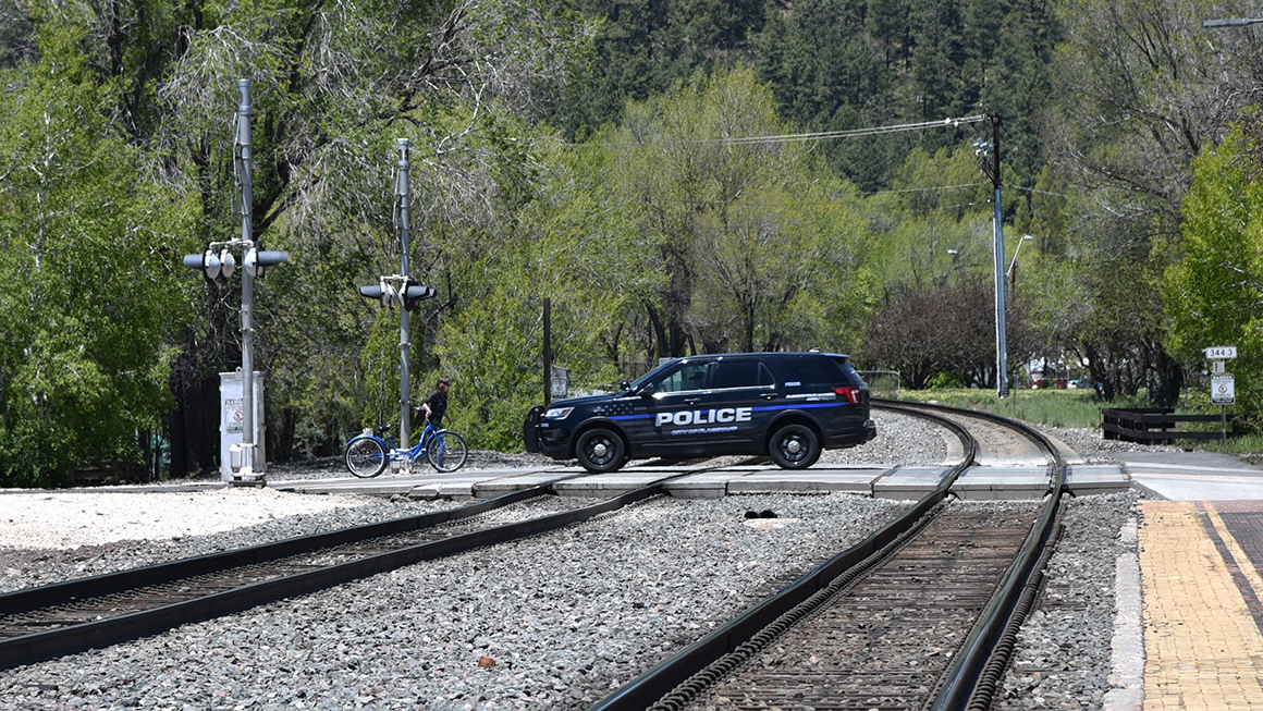 Flagstaff police car crossing the railroad tracks in Flagstaff Arizona