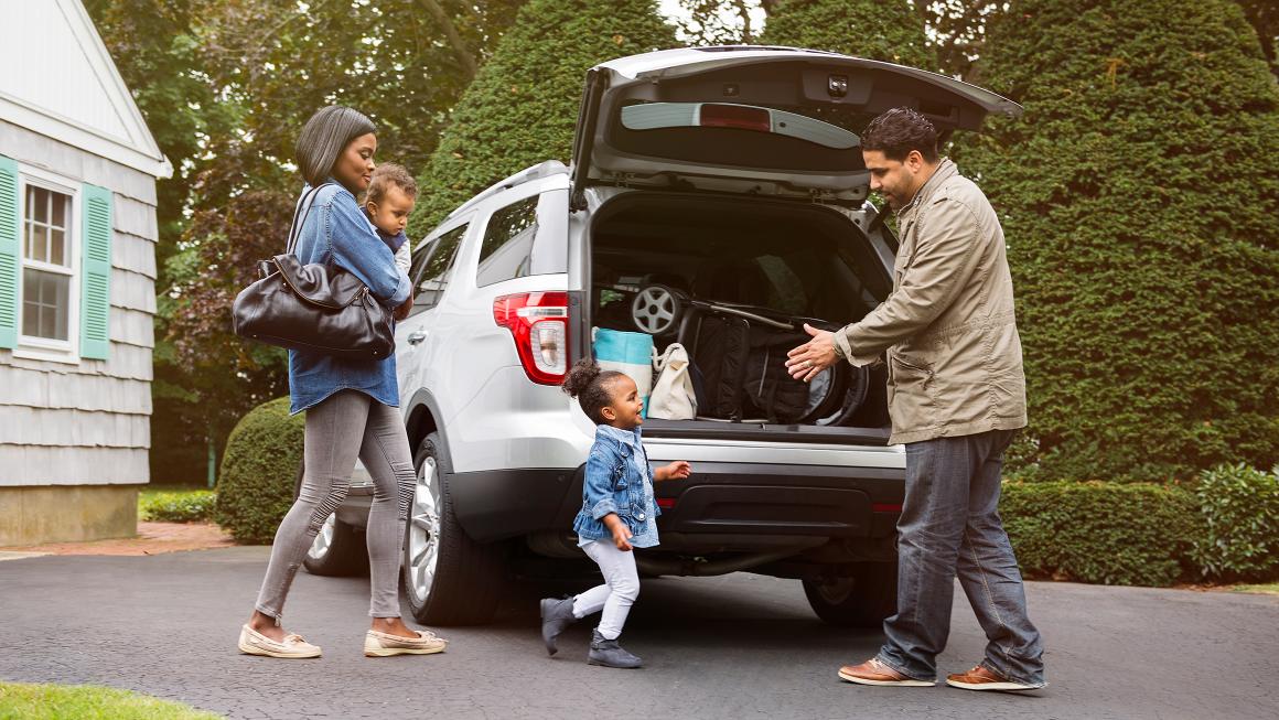 A family getting into their car.