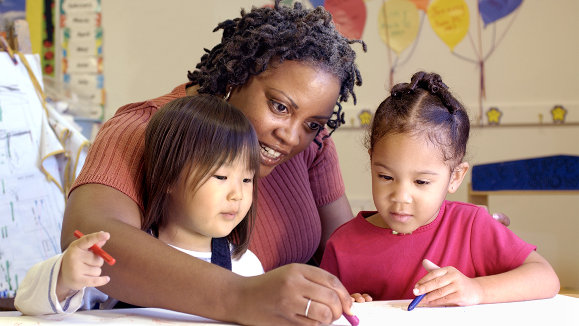 photo of teacher coloring with girls
