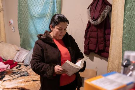 An undocumented Honduran immigrant reads her Bible during self-quarantine with her family for possible COVID-19 on March 30, 2020 in Mineola, New York. 