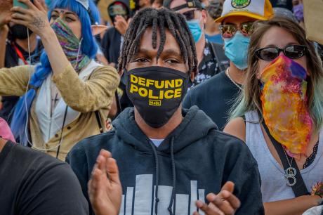 A participant wearing a face mask with the words Defund Police in it. Thousands of protesters gathered at Mc Carren Park in Brooklyn for a massive march around Williamsburg, making a loud call for the defunding of the police force. 