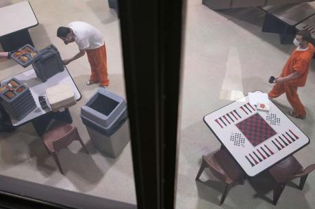 Incarcerated people don masks and receive lunch at St. Louis County Jail