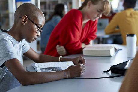 Student reads a book at school