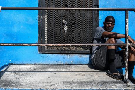 Man sits outside his house