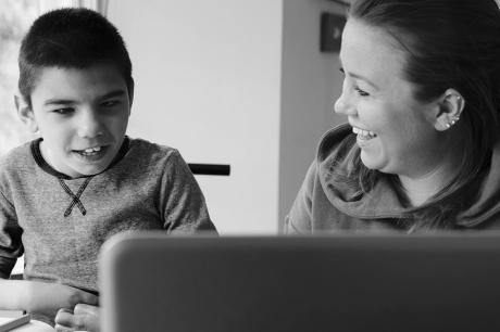 Parent tutors their young child with a disability