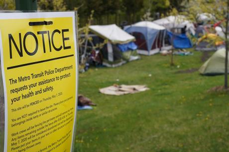 A sign a fast-growing homeless encampment 