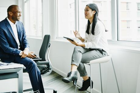 Colleagues speak at work