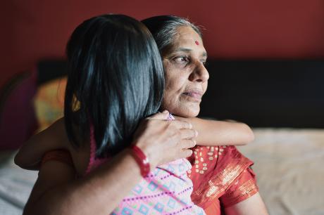 Mother and child embracing.