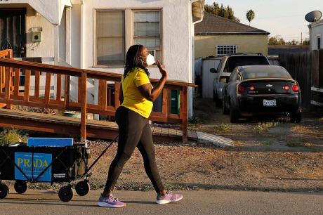 Sara Prada wheels materials for her school board run through her neighborhood as she campaigns ahead of the November 2020 election.