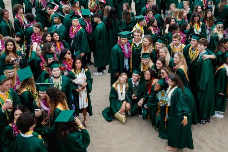 High School graduates pose for pictures next to the Manhattan Beach Pier