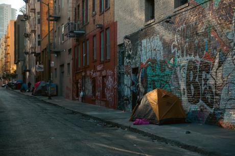 Several tents line an alley in the Tenderloin, a San Francisco neighborhood where many people experiencing homelessness live.