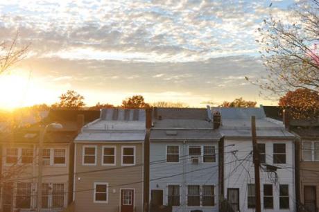 photo of sun over DC houses