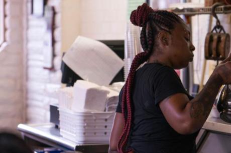 Server Donita Jackson fills water cups at the Florida Avenue Grill