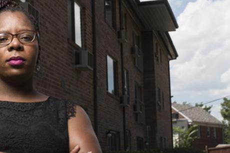 Jasmine White outside the Hawaiian Apartments building