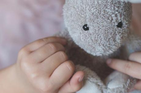 Girl playing with a small rabbit