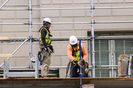 Construction workers put up scaffolding in Washington, DC on October 8, 2019