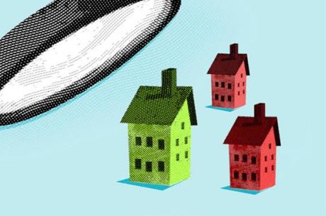 photo of magnifying glass looking at houses